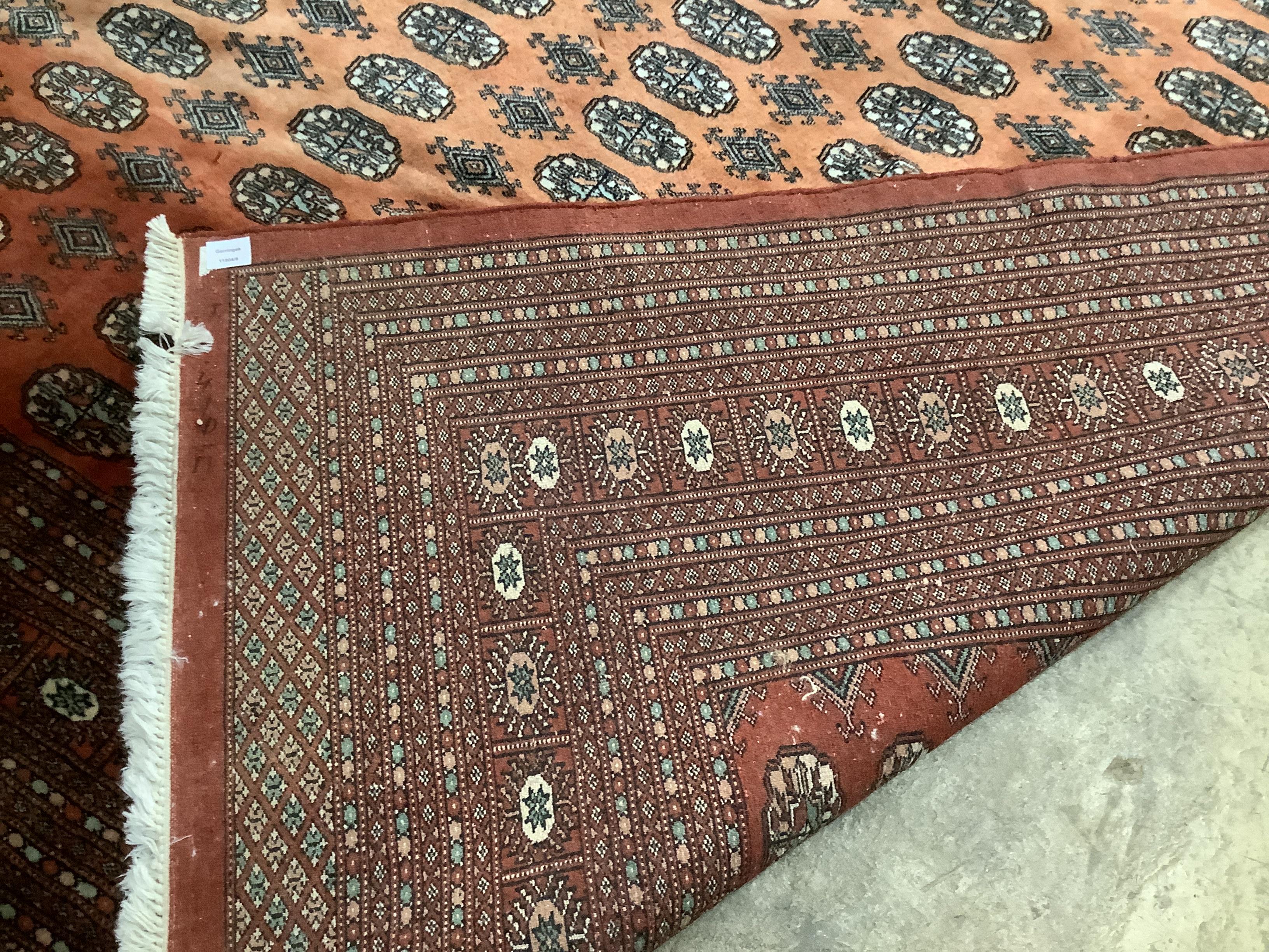 A Bokhara peach ground carpet, 364 x 275cm